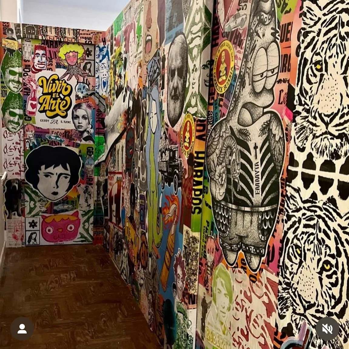 A narrow alley dense with street art and Benzorella stickers