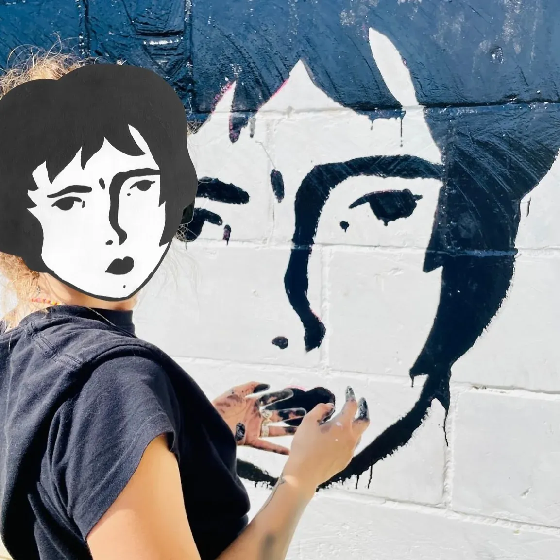 Painting a large Benzorella face onto a white wall