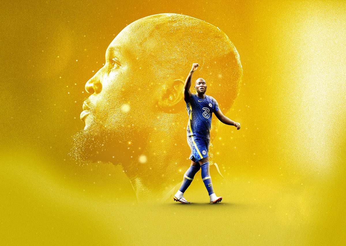 A footballer in a blue kit in action over a large golden portrait of himself