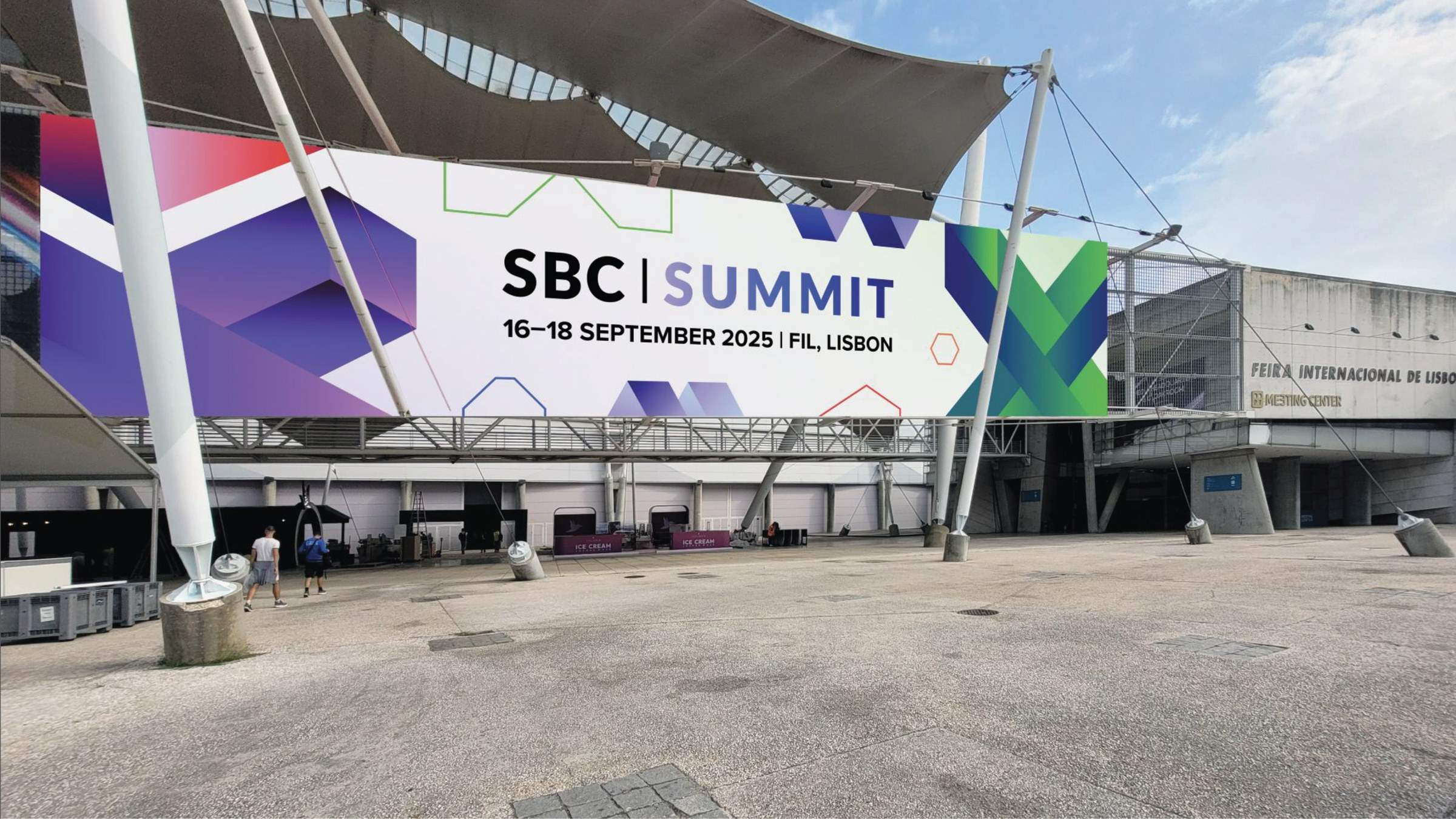 Exterior of the summit venue with large branded signage