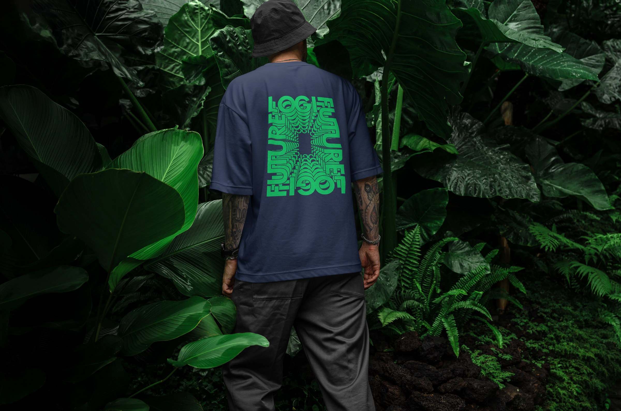 A person in a Logifuture t-shirt standing among tropical plants