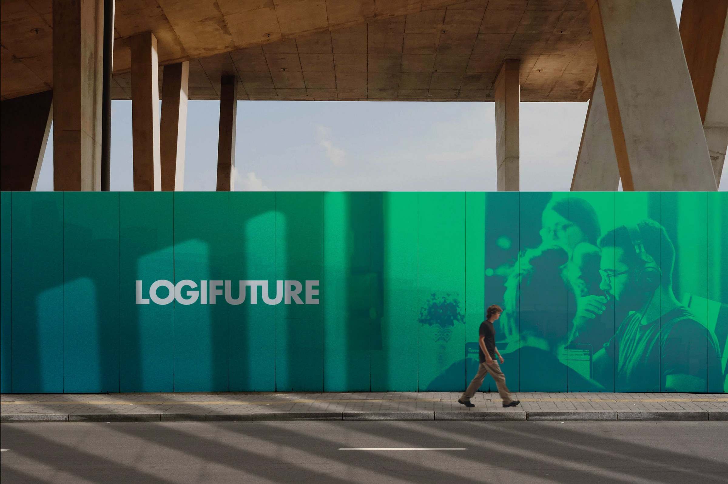 A long neon-green Logifuture hoarding wall in a city street, with a person walking past